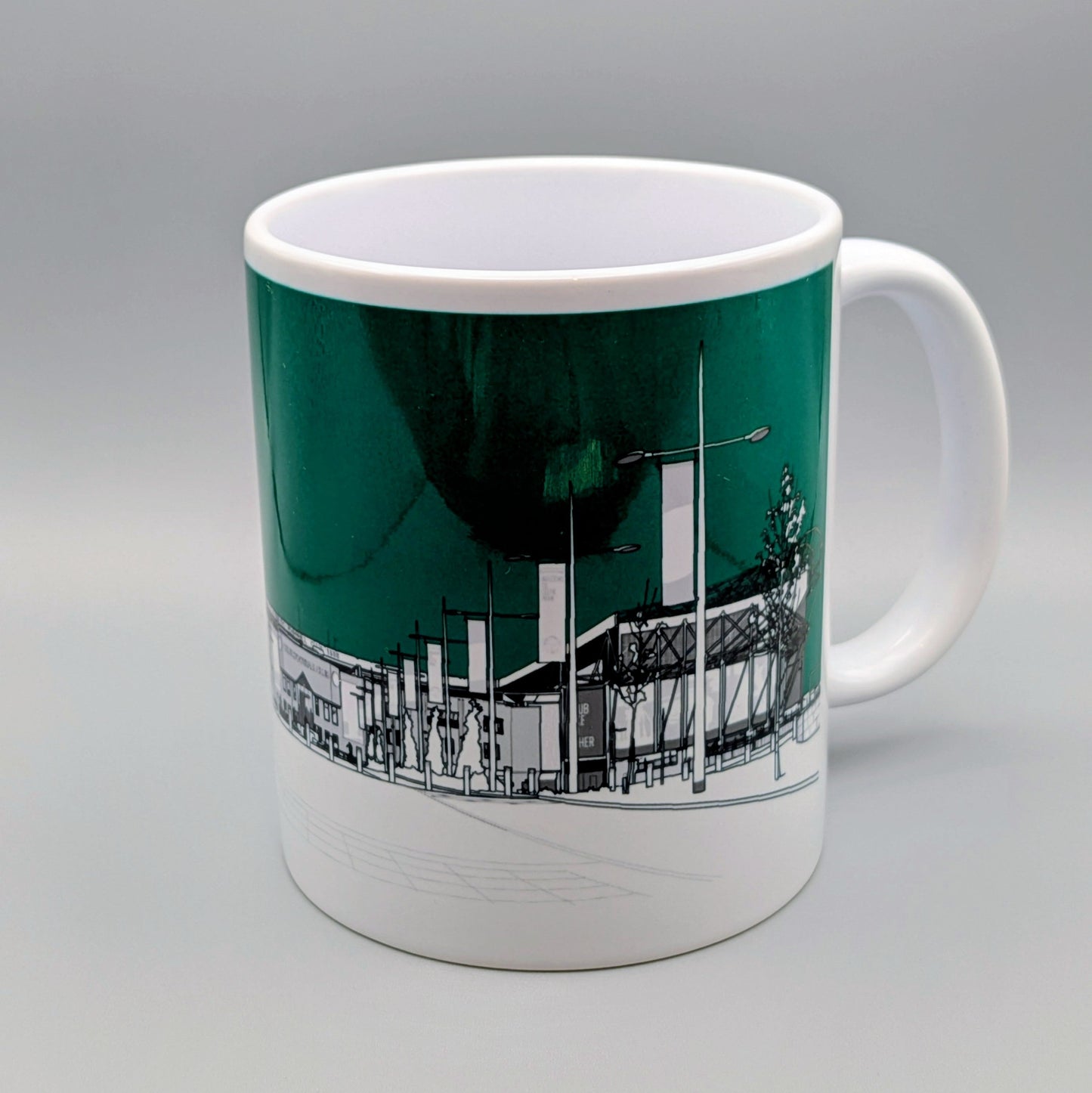Mug with a cityscape design on a green background