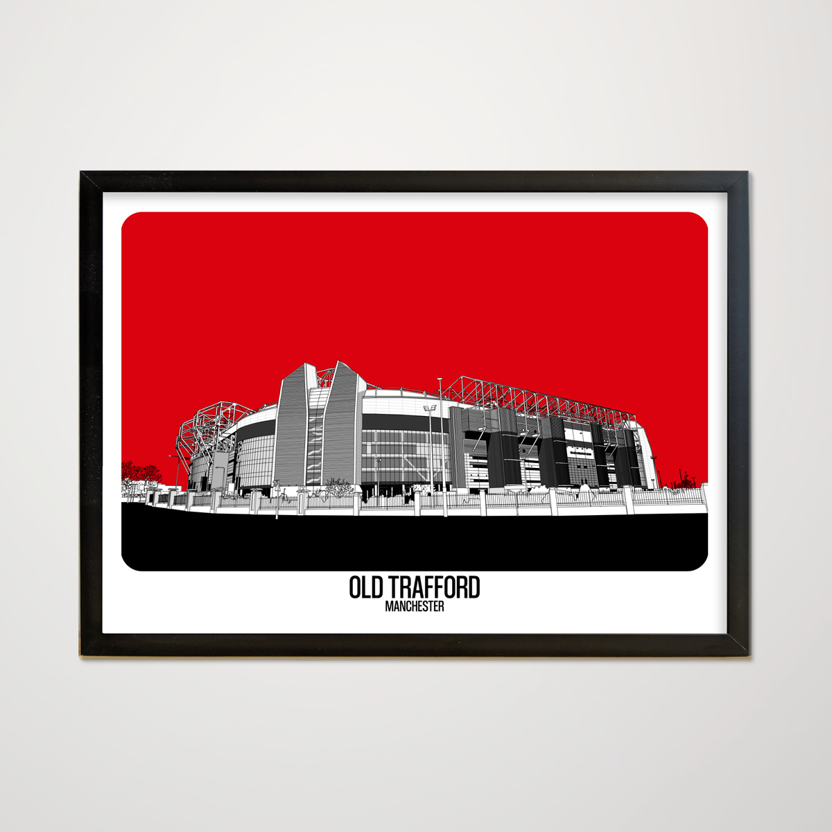 Framed artwork of Old Trafford stadium with a red background