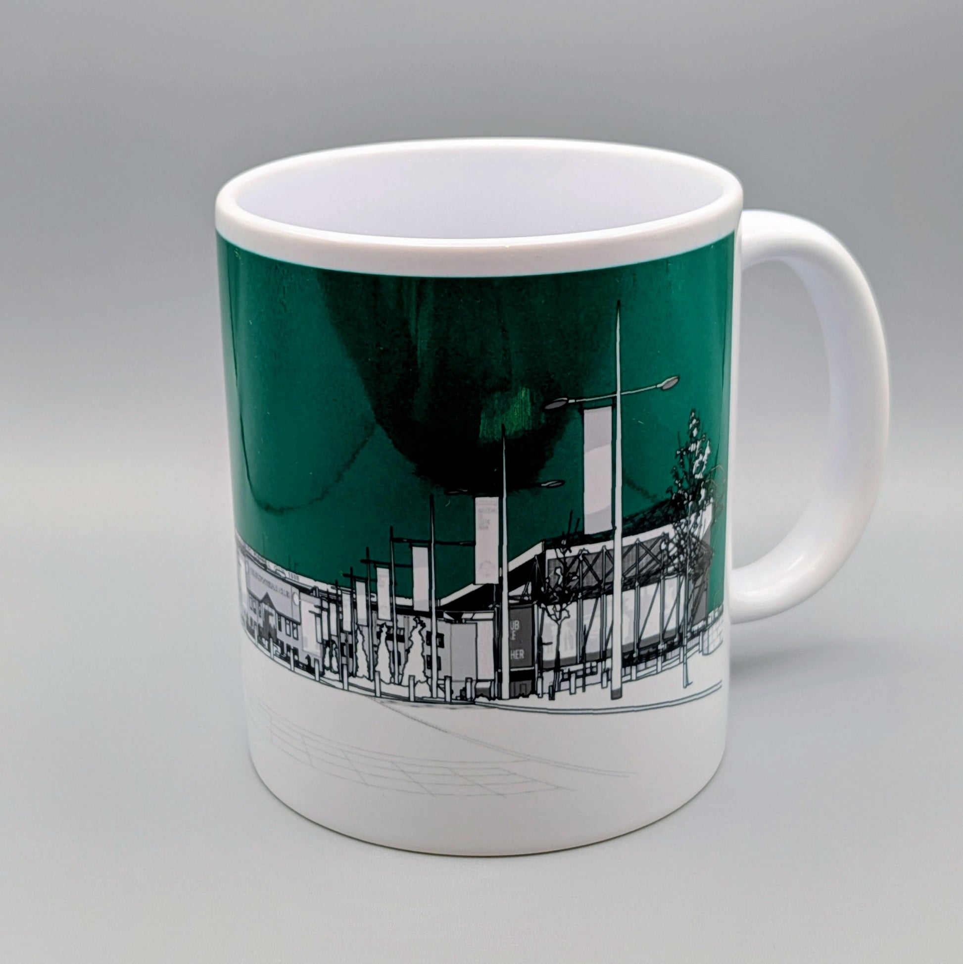 Mug with a cityscape design on a green background