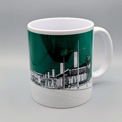 Mug with a cityscape design on a green background