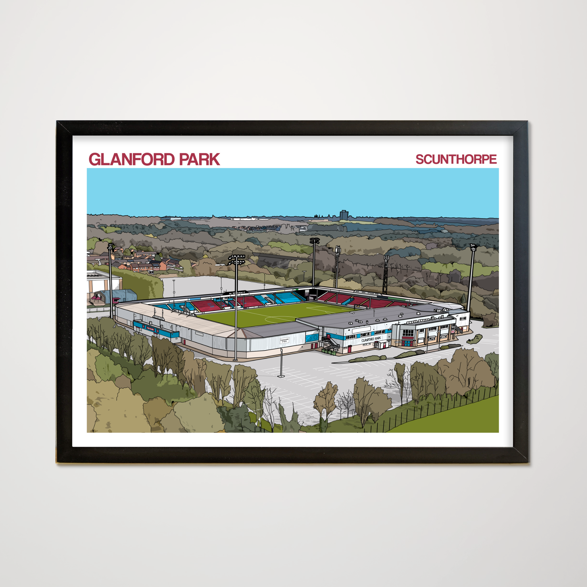 Framed artwork of Glanford Park stadium in Scunthorpe, displayed on a white wall.
